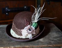 The Countess is a mini bowler hat in chocolate brown wool felt and trimmed with metallic copper lace and a vintage cream lace band. I've added a little rosette of lace, some bronze and copper clock hands and a copper cog topped off with a glitzy vintage button. There is also a little plume of feathers. size approx 13x18cm and height 8cm. it comes with a hat elasti, which is worn under the hair, and you can add extra hair pins too if you need them. Hat With Feather, Copper Lace, Derby Hats Fascinators, The Countess, Hat Fascinator, Hat Base, Vintage Mermaid, Lace Bands, Bowler Hat