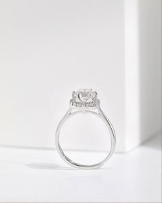 an engagement ring with two stones on the side and one stone in the middle, against a white background