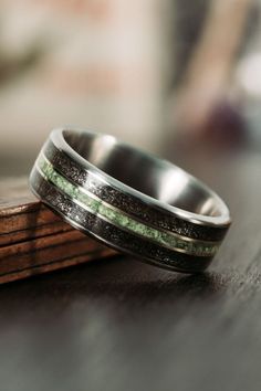 Interstellar-meteorite-dust-imperial-diopside-titanium-mens-wedding-band-rustic-and-main Scottish Wedding Rings, Modern Ring Design, Groom Wedding Band, Mens Wedding Rings Titanium, Wedding Band For Him, Mens Wedding Rings Unique, Meteorite Wedding Band, Groom Ring, Wood Wedding Band