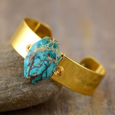 Not only does the Handmade Turquoise & Gold Cuff Bangle look great and make the perfect gift for someone. It will help you to have stress-free days and will bring you energy and wisdom Turquoise is a purification stone. Use it to dispel negative energies and protect you against pollutants or negative outside influences. It benefits the Throat Chakra with communication and expression of creativity - feeling comfortable to express your feelings - Artistically Inspired. Ancient Egyptians believed T Adjustable Cuff Bracelet With Natural Stones For Gift, Artisan Cuff Bracelet With Natural Stones As Gift, Adjustable Turquoise Cuff Bracelet As Gift, Adjustable Spiritual Cuff Bracelet With Natural Stones, Adjustable Spiritual Cuff Bracelet With Gemstone, Adjustable Spiritual Gemstone Cuff Bracelet, Turquoise Hand-wrapped Jewelry For Meditation, Adjustable Gemstone Cuff Bracelet For Healing, Spiritual Hand-wrapped Cuff Bracelet As Gift