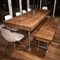 a wooden table with white chairs around it