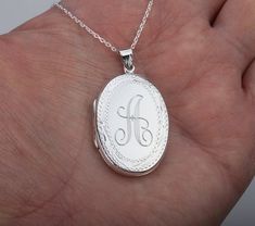 Carrying the pictures of your loved ones close to your heart all the time, this large personalized locket necklace features:1. a large (33 x 23 mm without bale), highly polished oval solid sterling silver locket (8.5 grams) that     can be engraved on the front and back (use pulldown menu to select); the front is perfect for a monogram engraving. The back has a larger area that allows for longer text engraving. Also possible are clipart style pictures, handwriting, fingerprint*, badge, map, logo Silver Oval Pendant For Personalized Gift, Silver Oval Pendant Jewelry For Personalized Gift, Personalized Silver Locket Necklace For Anniversary, Silver Oval Necklace For Anniversary Gift, Silver Oval Necklace For Anniversary, White Engraved Locket Necklace For Anniversary, Engraved Silver Locket Necklace For Anniversary, Elegant Oval Locket Necklace For Anniversary Gift, Elegant Oval Locket Necklace For Anniversary