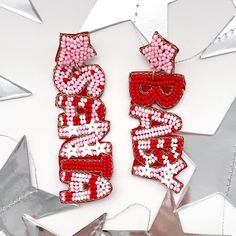 Get into the festive spirit with our Santa Baby pink and red Christmas Dangle Earrings!  These playful earrings feature one dangle seed bead earring that says "Santa" and the other "Baby," adding a touch of whimsy to your holiday look. The combination of pink and red hues creates a fun and vibrant accessory that embodies the true essence of Pinkmas joy. Make a statement with these merry earrings, perfect for the holiday season. Whether you're looking for a unique Christmas accessory or a gift that stands out, our Santa Baby earrings are the ideal choice. 🌟 Spread the holiday cheer and add festive flair to your ensemble with these delightful earrings. Get ready to jingle all the way and make your Christmas celebrations extra special! 🎁 🌸 Elevate Your Style with Trendy Earrings! 🌸 Welcom Cute Christmas Party Jewelry, Red Jewelry For Christmas Birthday, Festive Red Beaded Earrings For Pierced Ears, Festive Red Beaded Pierced Earrings, Red Earrings For Valentine's Day Holiday, Red Beaded Earrings For Festive Occasion, Red Christmas Earrings For Party, Red Beaded Earrings For Christmas, Red Earrings For Christmas Party