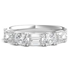 a three stone diamond ring with baguetts on the sides and side stones in white gold