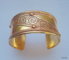 vintage antique gold vermeil gold gilded bangle bracelet cuff from rajasthan india. great handmade design good for jewelry collection.Inner circumeference - 15.5 cm (6.1")width - 3.2 cm (1.26") weight - 41 gramsmaterial - germen silver (metal) with gold plate. Vintage Gold Bangle With Intricate Design, Antique Gold Bangle Bracelet For Ceremonial Occasions, Antique Gold Bangle Bracelet For Ceremonies, Antique Gold Bangle Cuff Bracelet, Bohemian Gold Hallmarked Jewelry, Gold Engraved Brass Cuff Bracelet, Bohemian Gold Engraved Bracelets, Bohemian Gold Engraved Bracelet, Festive Gold Cuff Bracelet With Intricate Design