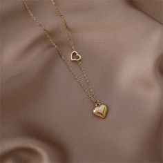 Make everyone fall head over heels for your look with this 18k gold-plated necklace decorated with two heart pendants. Chain : 15.75" L with 2.56" extender Pendant : 0.39" L Lobster claw clasp 18k gold-plated copper Heart Pendants, Two Hearts, Head Over Heels, Gold Plated Necklace, Heart Pendant Necklace, Lobster Claw, Heart Pendant, Gold Jewelry, Choker Necklace