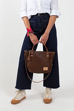 Your bag is proudly made in Lynchburg, Virginia using the finest materials in the world. W 13" x H 10.5" x 4" D 4.5 ” handle drop Made with soft, tumbled pebble grain natural Mocha Tuscan Leather* Removable/adjustable 1/2" crossbody strap that extends from 36" to 48" Straps are bench made with brown English Bridle leather* and solid brass hardware Interior zipper pocket and key clip Pinstripe fabric lining Solid brass hardware Made in the USA *Mocha Tuscan Leather is a vegetable tanned leather c Fall Travel Satchel In Pebbled Leather, Pebbled Leather Satchel For Travel In Fall, Everyday Saddle Bag With Detachable Top Handle, Fall Pebbled Leather Shoulder Bag With Double Handle, Everyday Satchel With Handle Drop In Pebbled Leather, Pebbled Leather Crossbody Shoulder Bag For On-the-go, Fall Pebbled Leather Satchel For Daily Use, Pebbled Leather Satchel For Daily Use In Fall, Fall Textured Leather Rectangular Satchel