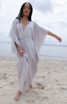 Perfect for poolside hangs or kicking it in the sand, this tie-front kaftan is the perfect accessory to add to your sun-loving wardrobe. V-neck
 Short sleeves 100% polyester satin Hand wash, line dry
 Imported Model stats: 5'10", 32" bust, 25" waist, 36" hip. Model is wearing size One Size. V-neck Beach Dress With Tie Waist For Vacation, V-neck Kaftan For Spring Vacation, Unlined V-neck Cover-up For Vacation, Bohemian Beach Dress With Tie Waist, Summer V-neck Kaftan For Vacation, Beachy V-neck Kaftan For Vacation, Chic Beach Kaftan With Kimono Sleeves, Summer Beach Kaftan With Kimono Sleeves, Kimono Sleeve Kaftan For Beach Day Out