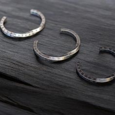 Embrace the mystique of ancient legends with our Viking Twisted Bangle Bracelet with Nordic Runes. This Stainless Steel Hammered Torc is more than just a piece of jewelry--it's a powerful emblem of strength and heritage designed for the modern man. Meticulously crafted from durable stainless steel, this bangle features an intricate twisted design and authentic Nordic runes that pay homage to Viking craftsmanship. The hammered finish adds a rugged, yet refined touch, making it a standout piece in Nordic Runes, Twisted Bangle, Celtic Mythology, Robust Design, Memorable Gifts, Modern Man, Accessories Unique, Bangle Bracelet, Runes