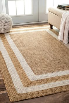 a beige rug with white stripes on the floor