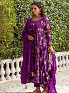 This Set Has a Anarkali, bottom and dupatta. Floral printed tier Anarkali set with hand embroided yoke. It is paired with matching chanderi foil print dupatta enhanced with fabric detailing and palazzo pants. Color: Purple Fabric: Anarkali - Cotton Silk Bottom - Shantoon Dupatta - Chanderi Product Details: Neck Type - Round neck Anarkali Length - 50 inches Bottom Length - 38-40 inches Sleeve Length - 22 inches Note: Available in other colors The product will be delivered within 2-4 weeks of orde Purple Palazzo Set With Sheer Dupatta For Diwali, Navratri Purple Palazzo Set With Cutdana, Purple Anarkali Palazzo Set With Cutdana, Traditional Drape Palazzo Set With Printed Motifs, Bollywood Style Anarkali Set With Printed Motifs For Wedding, Wedding Anarkali Set With Printed Motifs For Navratri, Purple Anarkali Palazzo Set In Chanderi, Festive Georgette Lehenga With Printed Motifs, Chanderi Sharara For Transitional Season