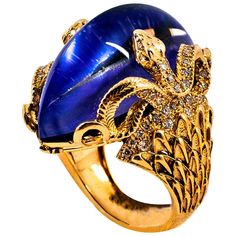 This Ring is made of 14K Yellow Gold. This Ring is available also in White Gold or in 18K Yellow (Or White) Gold. This Ring has 0.76 Carats of White Modern Round Cut Diamonds. This Ring has a 36.25 Carats Lapis Lazuli Triplet Stone: the stone is composed of three layers: The first layer consisting of a Lapis Lazuli, the second consisting of Mother of Pearl, the third consisting of Rock Crystal. These Three Stones create a new gem, with a three-dimensional effect rich in shades of blue / purple w Yellow Gold Cocktail Ring, Jewellery Design Sketches, Gold Dragon, Bleu Violet, Gold Cocktail Ring, Purple Pearl, Gold Cocktail, Snake Ring, Domed Ring