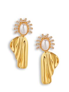 The Renita Statement Earrings offer an heirloom-worthy design with a sleek glass pearl and glass studs to create an ethereal flow. From our bridal collection, they bring an exquisite elegance to redefine bridal beauty. DETAILS 18K gold-plated brass CZ stones Glass pearl Approx. 1" H, 2.2" W Post & clip back 100% lead & nickel free Anti-allergy Glamorous Gold-tone Jewelry For Wedding, Glamorous Gold-tone Wedding Jewelry, Gold Pearl Embellished Chic Earrings, Elegant Gold-tone Earrings For Evening, Elegant Gold-tone Evening Earrings, Glamorous Gold Pearl Earrings, Gold Pearl Embellished Earrings For Wedding, Glamorous Gold Plated Earrings For Weddings, Glamorous Gold Pearl Earrings For Wedding