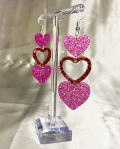 Super cute Heart Earrings in retro style - super sparkly, fun and unique! These are made from high-quality resin and glitter, making them lightweight and comfortable. All earrings are handmade and designed by myself. If you have any questions please feel free to ask, I will respond same or within 1 business day. Your feedback and concerns are very important to me. Your satisfaction is 100% guaranteed. If you are unhappy with your purchase, please give me a chance to resolve your concerns before leaving feedback. All Earrings are posted within 5 working days. If you need them quicker, please drop me a message and I see what I can do. Standard Postage: All earrings are posted with Royal Mail. UK deliveries are shipped with 2nd Class Standard and take 2-3 working days, unless you select Expre Handmade Jewelry For Valentine's Day Party, Cute Jewelry For Valentine's Day Party, Cute Valentine's Day Party Jewelry, Pink Glitter Heart Earrings For Party, Cute Heart Drop Earrings For Party, Multicolor Earrings For Valentine's Day Party, Cute Heart Earrings For Party, Glitter Red Earrings For Gifts, Red Glitter Earrings For Gift