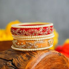 Elevate your jewellery game with our handcrafted velvet pearl bangles with zari and mirror work, exuding elegance and charm. Unveil the luxury with 3 bangles in every order, thoughtfully presented in delicate potli bags. Adorn yourself with the timeless allure of pearls and make a statement that resonates. Don't wait, shop now! Note: Our product is available in multi colours, but colour choice is not available. We will send them based on availability. Leave a note at checkout, and we'll try to a Traditional Bridal Sets For Diwali, Chandbali Wedding Bracelets With Zari Work, Diwali Temple Jewelry Bridal Sets With Zari Work, Traditional Bangle For Festivals Gift, Adjustable Wedding Jewelry With Zari Work, Temple Jewelry Bridal Sets For Diwali, Adjustable Zari Work Jewelry For Wedding, Adjustable Zari Work Wedding Jewelry, Festive Chandbali Bridal Set For Diwali