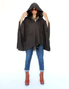 "🚚..ALL ORDERS ARE SHIPPED VIA DHL EXPRESS MAIL Dreamy, poncho style layer. Oversized and effortless, with a hoodie. Features a front pockets and button closures at front and side. Continue to enjoy perfect outdoor days after the temperature turns a little chilly. * Hooded; Button closure * Open sides with button closure * Two front pockets * Oversize, cozy silhouette * Unlined Measurements approximately: Sleeve Length (from side of neckline): 23\" (58 cm) Bust: 48\" (122 cm- all around) Approx One Size Hooded Cape For Fall, One Size Fall Cape For Outdoor Wear, One Size Cape For Outdoor Fall Activities, One Size Outdoor Cape For Fall, One-size Outdoor Cape For Fall, Oversized Cape Poncho For Outdoor, Outdoor Poncho With Cape Shape, Oversized Gray Cape For Fall, Oversized Outdoor Cape Poncho