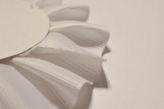 a close up view of a white flower on a table with the petals still attached