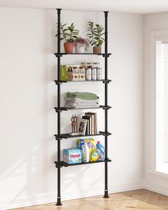 a book shelf with books and plants on it