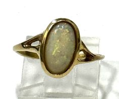 Ladies' vintage 14kt yellow gold ring with oval shape Australian opal center gem 12x6mm  *14k yellow gold *Total weight 2.5 grams *Size 7 (U.S.) can be resized with no charge Oval Gold Opal Ring In 14k Gold, Classic Yellow Gold Opal Ring, Heirloom Oval Opal Ring For Formal Occasions, Oval Opal Ring In Yellow Gold Stamped 14k, Formal Hallmarked Oval Cabochon Opal Ring, Formal Oval Cabochon Opal Ring, Collectible Opal Ring In 14k Gold, Oval Opal Ring Stamped 14k For Anniversary, Classic Oval Opal Ring Collectible