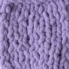 a purple crocheted dishcloth on a white surface