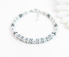 "Beaded Name Bracelet: Created with 4.5mm sterling silver alphabet blocks and loads of gorgeous sterling silver accent beads. The name on the bracelet can be hers, her child or grandchild's name, or something like Nana, Mimi, Grandma, Mommy, etc. The base price includes 6 letters. Each additional letter is $2. I can usually fit two names on the bracelet if desired. C H O O S E . Y O U R . C L A S P Twisted Heart Toggle Plain Heart Toggle Round Toggle Lobster Clasp with 1/2\" extender chain Arriv Classic Letter Beads Jewelry As Gift, Classic Letter Beads Jewelry Gift, Elegant Silver Name Bracelet With Letter Beads, Silver Beaded Bracelet With Letter Beads, Silver Engraved Round Bead Bracelets, Silver Engraved Round Beads Bracelet, Personalized Sterling Silver Bracelets With Round Beads, Silver Charm Bracelet With Letter Beads For Gift, Silver Charm Bracelet With Letter Beads As Gift