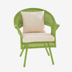 a green chair with a white pillow on it's back and the seat upholstered