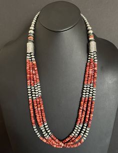 Add a pop of color to your jewelry collection with this stunning multi-strand beaded necklace. The necklace features vibrant red spiny oyster pearls that are perfectly complemented by the .925 sterling silver metal. Measuring 30 inches in length, this beaded necklace is perfect for both casual and formal occasions. The necklace is created in a Southwestern style and is adorned with intricate beading that adds to its unique design. It is a perfect addition to any jewelry collection and is sure to Multi-strand Red Coral Necklace With Polished Beads, Bohemian Pearl Necklace With Polished Beads In Silver, Bohemian Silver Pearl Necklace With Polished Beads, Silver Southwestern Beads For Gifts, Unique Jewelry With Polished Red Coral Beads, Unique Silver Multi-strand Beaded Necklaces, Red Coral Jewelry With Natural Stones In Round Beads, Unique Red Coral Jewelry With Polished Beads, Sterling Silver Beaded Multi-strand Jewelry