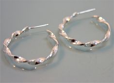 "These Spiral Twist earrings are fabricated from sheet sterling silver and handmade from start to finish. They are the perfect size hoop for everyday wear. 1\" diameter, apporx 3mm width and 1mm\" thick silver. Earrings also have a sterling silver post and back. For an alternative look, these can also be fabricated with a satin finish. All items are presented in a 100% recycled paper box with a paper raffia bow. Thank you for looking at my shop. http://www.etsy.com/shop/tinysparklestudio For LEA Silver Spiral Hoop Earrings For Everyday, Everyday Spiral Silver Hoop Earrings, Everyday Silver Spiral Hoop Earrings, Nickel-free Spiral Hoop Earrings For Gift, Minimalist Spiral Sterling Silver Hoop Earrings, Handmade Spiral Silver Hoop Earrings, Spiral Sterling Silver Hoop Earrings, Spiral Nickel-free Metal Hoop Earrings, Nickel-free Silver Spiral Hoop Earrings