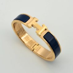 H BLUE BRACELET Luxury Jewelry With Gold Clasp For Gift, Blue Luxury Bangle For Formal Occasions, Timeless Blue Bracelet For Formal Occasions, Luxury Blue Bangle Jewelry, Elegant Blue Gold Bracelet For Formal Occasions, Blue Bangle With Polished Finish, Elegant Blue Bangle Gold Bracelet, Luxury 14k Gold Sapphire Jewelry, Luxury Sapphire Jewelry In 14k Gold