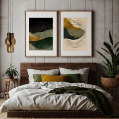 two paintings hang on the wall above a bed