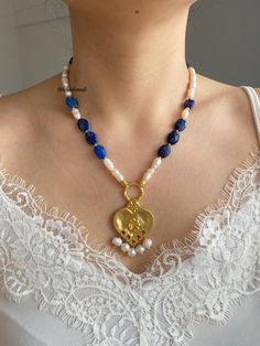 Lapis lazuli and freshwater pearl gold plated necklace with heart pendant 💓 All gold looking pieces are gold plated. You can wear this chic necklace every day💞 *Please try not to wear your jewelry while exercising, in shower or while sleeping .  *Also , is best to keep away from chemicals, lotions or strong perfumes . Cleaning them with a simple polished cloth is ideal .  FAST FREE SHIPPING! If you have any questions feel free to contact💌 Love from tarcinshands! Gold Heart-shaped Pearl Beaded Necklaces, Gold Heart-shaped Pearl Beaded Necklace, Baroque Pearl Necklaces With Natural Stones For Gifts, Gift Necklace With Natural Stones And Baroque Pearl, Baroque Pearl Necklace With Natural Stones For Gift, Elegant Blue Beaded Necklace With Heart Beads, Blue Lapis Lazuli Pearl Necklace Gift, Handmade Pearl Heart Pendant Jewelry, Blue Beaded Necklace With Pearl Drop For Gift