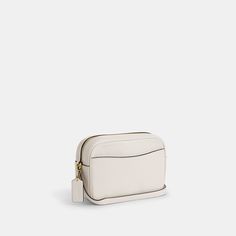 a small white bag with a zipper on the front and an attached strap to it