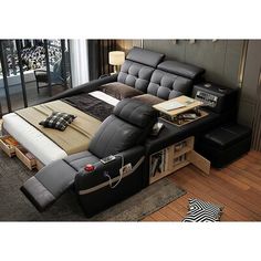 a black leather reclining bed with pillows on it