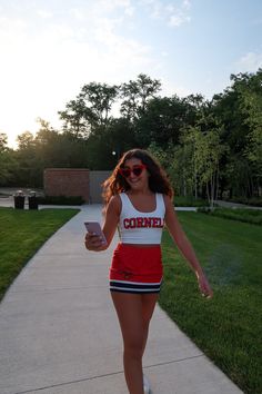 CORNELL! The cutest Cornell Game Day Skirt is here! Our stretchy and soft skirt is the perfect material to wear all day long. Pair with our Cornell Babydoll Tee for a one of a kind game day look! Our elastic waist band makes this skirt super comfortable and flattering. In stock & ships in 1-2 business days. 88% Micropoly, 12% Spandex. Runs slightly small - order a size up if in between sizes. 1" Elastic waistband. Model in pictures is wearing a size Medium. Machine wash cold. Tumble Dry low. Casual Cheerleading Skort With Elastic Waistband, Casual Summer Cheerleading Skort, Sporty Mini Skort For Day Out, Sporty Red Tennis Skirt For Summer, Casual Cotton Cheerleading Skirt, Casual Mini Skirt For Cheerleading In Spring, Casual Cotton Tennis Skirt For Cheerleading, Casual Cotton Skirt For Cheerleading, Casual Tennis Skirt With Elastic Waistband For Cheerleading