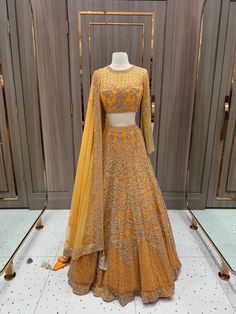 Introducing the Dhanshika Lehenga, your new go-to for elegant yet playful style. With its unique design and quirky details, this lehenga is sure to make a statement at any event. Embrace your fun-loving side with the Dhanshika Lehenga. Fabric: Net with Silk Lining! WASH CARE INSTRUCTIONS - Please Dry clean only when it is applicable. Ready to Ship! Designer Lehenga Saree With Dabka Work, Party Wear Lehenga Shaped Like Saree For Reception, Festive Orange Lehenga, Designer Dola Silk Lehenga With Cutdana, Cutdana Dola Silk Lehenga For Formal Events, Designer Orange Lehenga For Festivals, Designer Lehenga With Traditional Drape For Eid, Designer Traditional Drape Lehenga For Eid, Bollywood Designer Lehenga With Resham Embroidery