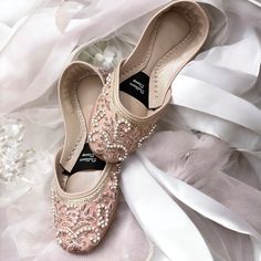 Introducing our exquisite RoseGold Bridal Khussa, a true masterpiece crafted to enhance your special day with elegance and comfort. Meticulously handcrafted with genuine leather and adorned with high-quality silk, these Khussa shoes are the epitome of luxury and style. Each pair is a testament to the artistry of our skilled artisans, featuring intricate cora and beadwork that adds a touch of regal charm. But beauty is not the only aspect we've considered; we've prioritized your comfort as well. Pink Closed Toe Wedding Shoes, Elegant Embellished Slip-on Flats, Elegant Almond Toe Ballet Flats For Wedding, Pearl Embellished Wedding Flats, Elegant Wedding Ballet Flats With Round Toe, Elegant Round Toe Ballet Flats For Wedding, Elegant Pink Flats For Wedding, Elegant Wedding Ballet Flats, Elegant Pink Wedding Flats