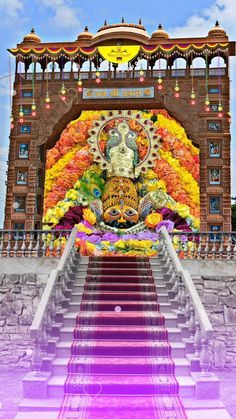 the steps leading up to an ornate building with a buddha statue on it's side