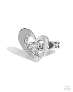 Embellished in glistening white rhinestones, an abstract silver heart is centered inside an oversized, abstract, sleek silver heart atop the finger for a radically romantic look. Features a dainty stretchy band for a flexible fit.   Sold as one individual ring. Elegant Metal Heart Ring For Promise, Elegant Metal Heart Ring For Wedding, Modern Sterling Silver Heart Ring, Elegant Heart-shaped Metal Rings, Elegant Heart Shaped Metal Rings, Elegant Metal Heart Ring For Anniversary, Silver Heart Shaped Metal Ring, Valentine's Day Diamond Heart Ring In Silver, Valentine's Day Silver Heart Diamond Ring