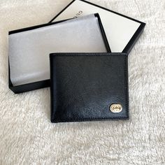 Very Unique Bifold Men’s Wallet From Gucci Featuring Glass Finish Leather And Brand Plaquet Logo Luxe Calf Leather W/ Smooth Finish Classic Black Front Plaquet Logo With Silver/Gold Details Bifold Closure 8 Individual Card Slots 2 Bill Compartments 2 Side Slots Black Business Wallet With Logo Plaque, Classic Bifold Wallet With Engraved Logo, Luxury Wallet With Logo Plaque For Everyday Use, Black Wallets With Logo Plaque For Everyday Use, Luxury Wallet With Logo Plaque, Designer Business Wallet With Logo Plaque, Classic Leather Wallet With Logo Plaque, Classic Black Wallet With Engraved Logo, Classic Leather Wallets With Logo Plaque