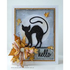 a card with an image of a black cat and autumn leaves on the bottom right corner