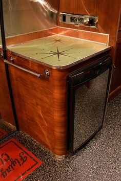 a stove top oven sitting inside of a wooden cabinet