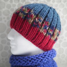 a knitted hat and scarf sitting on top of a mannequin's head