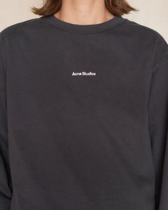 Logo longsleeve T-shirt by Acne Studios in black. Relaxed fit crewneck tee crafted from midweight cotton jersey. A wardrobe essential featuring the iconic logo stamped on the center front, adding a touch of contemporary chic. 100% Cotton.Made in Portugal. Sporty Branded T-shirt For Fall, Urban Tops With Branding For Fall, Crew Neck Cotton Sweatshirt, Basic Crew Neck Tops With Logo Detail, Long Sleeve Tops With Logo For Streetwear, Classic Long Sleeve Tops With Logo Print, Classic Tops With Logo Detail For Fall, Classic Long Sleeve Tops With Logo, Cotton Long Sleeve Tops With Logo