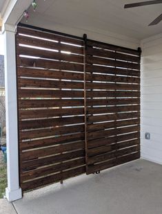 a large wooden gate on the side of a house