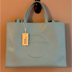 Telfar Medium Pool Blue Shopping Bag Sold Out Never Used Designer Light Blue Shoulder Bag For Daily Use, Designer Light Blue Top Handle Shoulder Bag, Designer Blue Bag With Top Carry Handle, Luxury Light Blue Tote Shoulder Bag, Designer Light Blue Bag With Detachable Handle, Designer Blue Bag With Double Handle, Designer Light Blue Bags For Everyday, Light Blue Shoulder Bag For Shopping, Light Blue Tote Bag With Detachable Handle