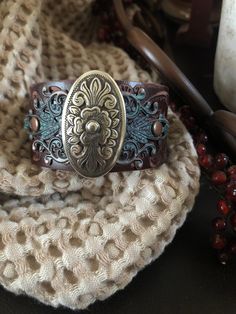 "Country leather bracelet cuff, western jewelry Embossed distressed genuine brown leather 1 1/2\" strap has been adorned with an oval southwestern silver concho which sets on a detailed antiqued copper filigree which has been given a rich patina. It is attached to the leather with two antiqued copper rivets. One antiqued copper snap has been placed to fit up to a 7 1/4\" wrist. I can add another snap if you would like a smaller or larger size but you need to convo me before purchasing The last p Vintage Concho Leather Bracelet For Festival, Southwestern Style Brown Concho Bracelets, Vintage Leather Concho Bracelet For Festival, Handmade Western Style Cuff Bracelets, Vintage Brown Jewelry For Rodeo, Southwestern Leather Bracelet With Concho For Gifts, Southwestern Leather Bracelet With Concho As Gift, Western Style Leather Bracelet With Concho, Western Style Leather Bracelet With Concho As Gift