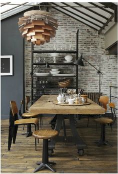 an industrial style dining room with exposed brick walls