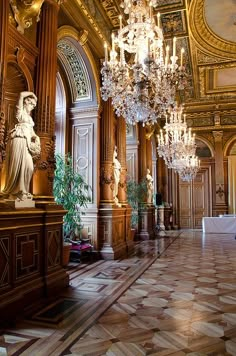 an ornate room with chandeliers and paintings on the walls