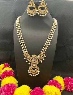 Embrace the cultural opulence of Long Rani Haram Set with Pearls, where each set is a work of art. Whether you're attending weddings, cultural events, celebrating important occasions, or simply seeking to add a meaningful touch to your attire, this necklace promises to adorn you with grace and the timeless charm of traditional jewelry. Elevate your style with cultural flair - order yours now! Here are some of the best ways to care for your artificial jewelry: *Keep it dry away and from moisture. Elegant White Jewelry For Navratri, Ceremonial Pearl Chain Jewelry For Festivals, Elegant White Pearl Necklace For Festivals, Ceremonial Festival Jewelry With Pearl Chain, White Jewelry For Navratri Ceremonial, White Temple Jewelry Sets With Intricate Design, Traditional Jewelry With Round Beads For Ceremonies, White Pearl Necklace With Intricate Design For Wedding, Traditional Round Beads Jewelry For Ceremonies