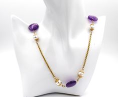 Necklace jewelry.  Amethyst and pearl Necklace with gold chain.  Handmade gemstone and gold bead caps on long necklace jewelry. Anniversary, birthday and graduation necklace jewelry.  An ideal gift for her. MATERIALS AND SIZE 20mm amethyst coin shape beads 10mm and 88mm white shell pearl beads 18k gold over stainless steel oval linked chain 18k gold over stainless steel jump rings 18k gold over stainless steel lobster claw clasp Gold wire bead caps (handmade) Necklace measures - -41 inches in length    Can be worn long as is or worn doubled up.   Fit for any occasion. Elegant Gold Amethyst Crystal Necklaces, Gold Single Strand Necklace As A Gift, Elegant Handmade Amethyst Pearl Necklace, Gold Single Strand Long Necklace As Gift, Elegant Gold Amethyst Necklace, Elegant Purple Chain Necklace For Gift, Gold Necklaces With Natural Stones For Anniversary, Long Necklace With Round Pearl Beads For Gift, Elegant Chain Necklace With Natural Stones As Gift